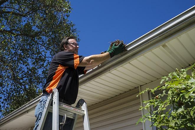 a gutter repair specialist working on a broken downspout in Azalea OR